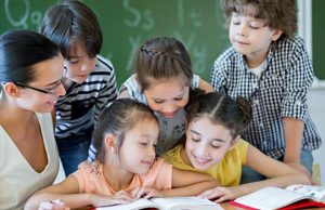 Elementary School Teacher Students 1200x800 Ts600 valutazione scuola primaria